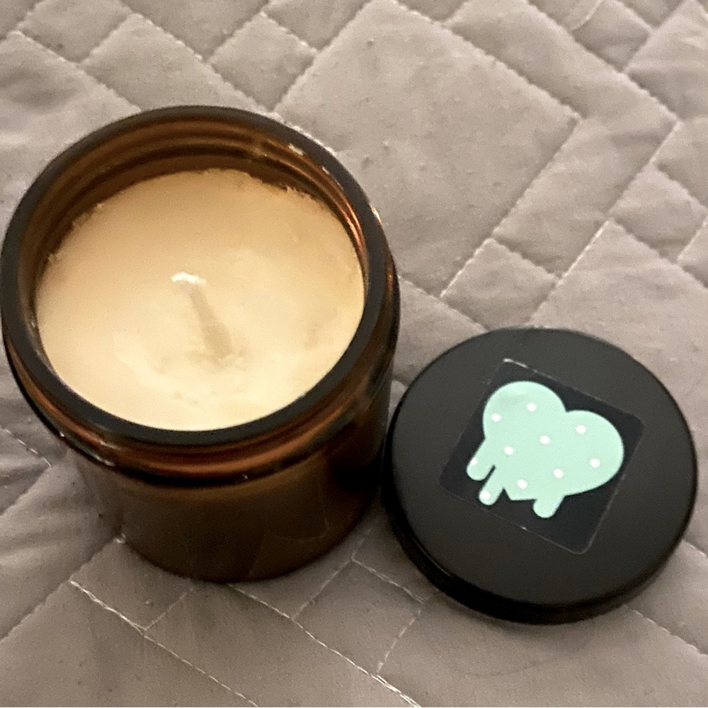 Amber colored glass with lotion candle